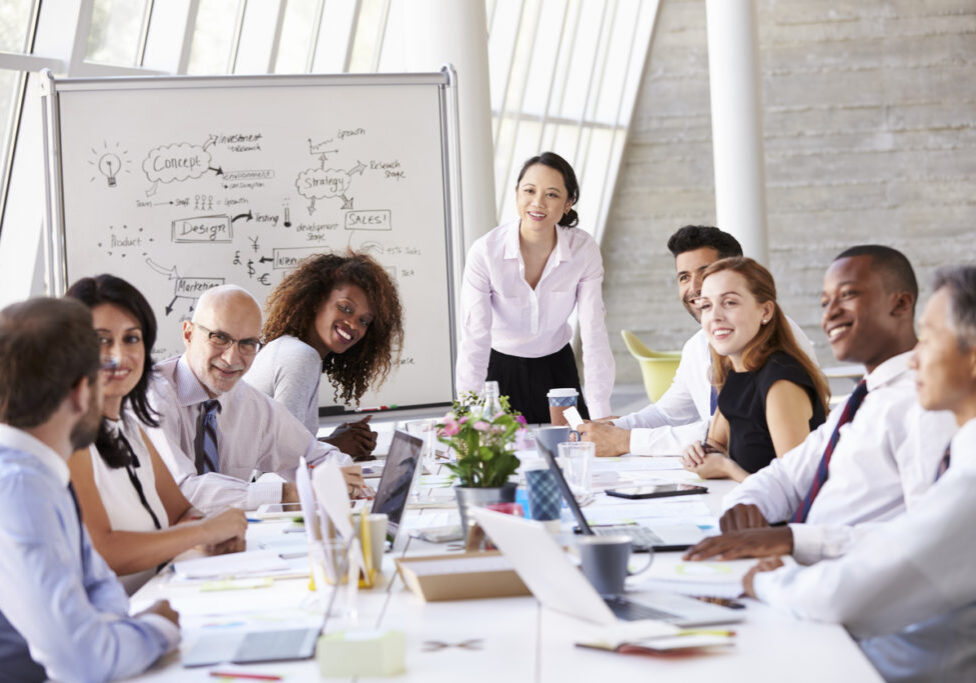 Asian Businesswoman Leading Meeting At Boardroom Table